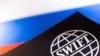 Swift logo is placed on a Russian flag are seen in this illustration taken, Bosnia and Herzegovina, February 25, 2022. REUTERS/Dado Ruvic/Illustration