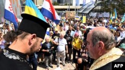 Ukrainian clergy say prayers during a protest against the Russian invasion of Ukraine, in Melbourne, Australia, on Feb. 27, 2022.