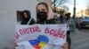 A person holds a sign that reads "We are against war" during a protest against Russian invasion of Ukraine, after President Vladimir Putin authorized a massive military operation, in Moscow, Feb. 27, 2022.