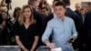 FILE - Ukrainian President Volodymyr Zelenskyy casts his ballot as his wife, Olena, stands nearby at a polling station during a parliamentary election in Kyiv on July 21, 2019.