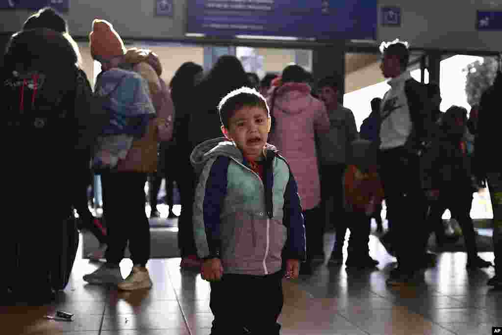 A refugee boy who fled conflict from neighboring Ukraine cries at the railway station after arriving to Zahony, Hungary, Feb. 27, 2022.