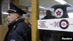 Policemen work inside the office of Russian radio station Ekho Moskvy, after an intruder attacked the station's anchor in Moscow, Oct. 23, 2017. 