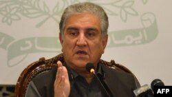 FILE - Pakistani Foreign Minister Shah Mahmood Qureshi gestures while addressing the members of the media in Islamabad, Feb. 25, 2022.