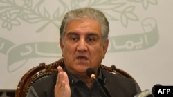FILE - Then-Pakistani Foreign Minister Shah Mahmood Qureshi gestures while addressing the members of the media in Islamabad, Feb. 25, 2022.