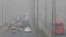 (FILE) In this Wednesday, Nov. 11, 2020 file photo, vehicles drive on a highway as smog envelops the area of Lahore, Pakistan. 