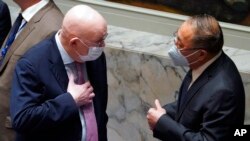 Vassily Nebenzia, left, Russia's U.N. ambassador, confers with Zhang Jun, China's ambassador, before a Security Council meeting on the Russian invasion of Ukraine, Feb. 25, 2022, at U.N. headquarters.
