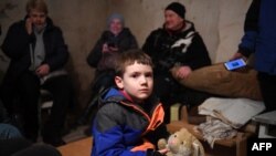 Mikhailo, 5, holds a toy as he waits in an underground shelter during a bombing alert in the Ukrainian capital of Kyiv on Feb. 26, 2022.