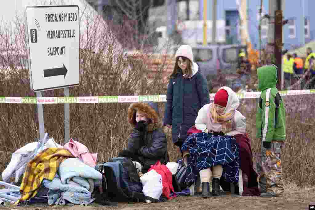 Refugees from Ukraine rest after arriving to the border crossing Vysne Nemecke, Slovakia, March 1, 2022. 