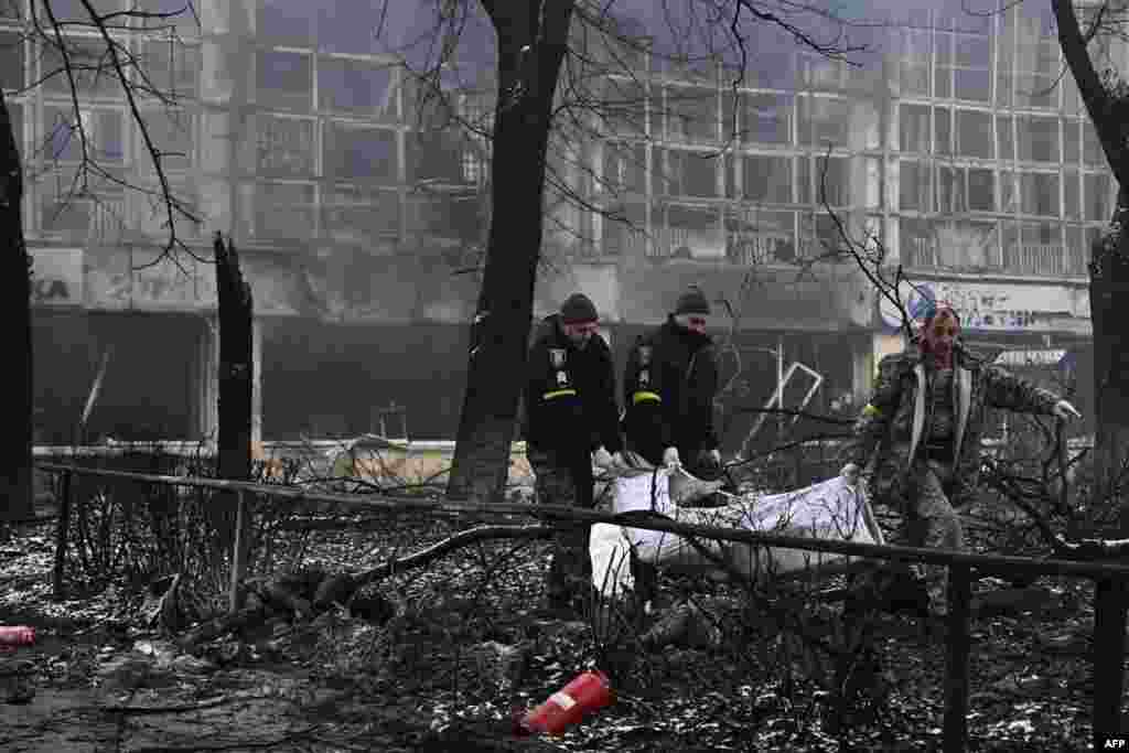 Police officers move the bodies of passersby killed in yesterday&#39;s airstrike that hit Kyiv&#39;s main television tower in Kyiv, Ukraine.
