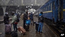 FILE - Nigerian students in Ukraine wait at the platform in Lviv railway station, Feb. 27, 2022, in Lviv, west Ukraine.