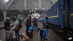 FILE - Nigerian students in Ukraine wait at the platform in Lviv railway station, Feb. 27, 2022, in Lviv, west Ukraine.