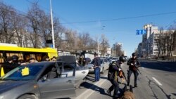 Police officers check people from a suspicious car they stopped, as Russia's invasion of Ukraine continues, in Kyiv, Ukraine February 28, 2022.