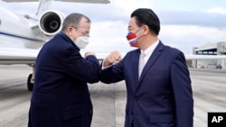 In this photo released by Taiwan's Ministry of Foreign Affairs, Taiwan's Foreign Minister Joseph Wu, right, greets former Chairman of the Joint Chiefs Adm. Mike Mullen. (Taiwan Ministry of Foreign Affairs via AP)