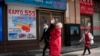 Residents past near shops at a mall, also known as Russia Market, for Russian traders on Feb. 26, 2022, in Beijing. 