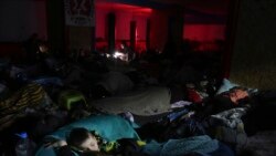 People sleep in the improvised bomb shelter in a sports center, which can accommodate up to 2000 people, in Mariupol, Ukraine, Feb. 27, 2022.