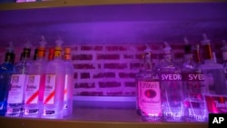 FILE - An empty space on a liquor shelf where Russian vodka used to be located at The Sidetrack, a gay bar on the north side of Chicago, July 29, 2013.