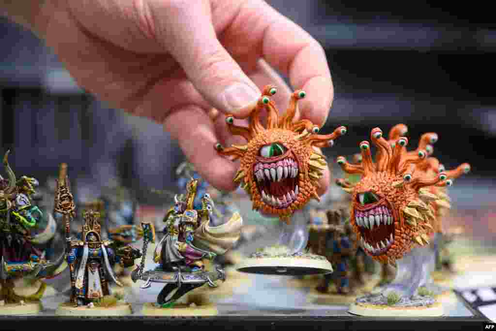 A wargamer moves around models before the start of the Warhammer 40,000 International Team Tournament held at Northampton County Cricket Ground in Northampton, north of London, Britain.
