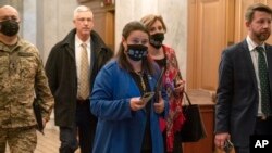 Ukrainian Ambassador Oksana Markarova, center, walks to a meeting with the Senate Ukraine Caucus, at the Capitol in Washington, Feb. 28, 2022.