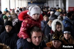 People wait to board an evacuation train from Kyiv to Lviv at Kyiv central train station following Russia's invasion of Ukraine, in Kyiv, March 1, 2022.