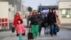 Ukrainian refugees arrive at the Medyka border crossing, Poland, Feb. 26, 2022. 