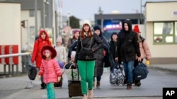 Ukrainian refugees arrive at the Medyka border crossing, Poland, Feb. 26, 2022. 