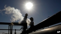 FILE - A Libyan oil worker, works at a refinery inside the Brega oil complex, in Brega, eastern Libya, Feb. 26, 2011.