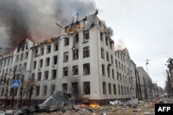 Firefighters work to contain a fire at the Economy Department building of Karazin Kharkiv National University in Kharkiv, Ukraine, allegedly hit during recent shelling by Russia, March 2, 2022.