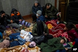 Afghans trying to flee Ukraine sleep inside Lviv railway station, in Lviv, west Ukraine, Feb. 28, 2022.