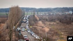 Cars wait to pick up family members and refugees fleeing the war in Ukraine, in Palanca, Moldova, March 2, 2022. 