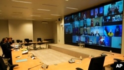 French President Emmanuel Macron, second left, watches the screen during a videoconference with NATO members at French Army headquarters, Feb. 25, 2022, in Paris. NATO leaders met to discuss how far they can go to challenge Russian President Vladimir Putin without engaging Russian forces in direct war.