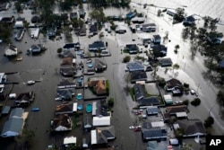 Homes are flooded in the aftermath of Hurricane Ida, Monday, Aug. 30, 2021, in Jean Lafitte, Louisiana. (AP Photo/David J. Phillip, File)