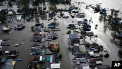 FILE - Homes are flooded in the aftermath of Hurricane Ida, Monday, Aug. 30, 2021, in Jean Lafitte, Louisiana. (AP Photo/David J. Phillip, File)