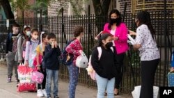 FILE —Teachers line up their students before entering PS 179 elementary school in the Kensington neighborhood, Sept. 29, 2020, in the Brooklyn borough of New York.