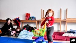 A girl plays at a temporary refugee shelter in Zahony, Hungary, near the Ukrainian border, Feb. 25, 2022.