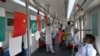 FILE - Passengers ride in an Orange Line Metro Train, a metro project planned under the China-Pakistan Economic Corridor, a day after an official opening in the eastern city of Lahore, Pakistan, Oct. 26, 2020.