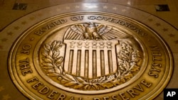 FILE - In this Feb. 5, 2018, photo, the seal of the U.S. Federal Reserve System is displayed in the Federal Reserve Board Building in Washington.