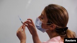 FILE - A medical worker prepares to administer a second vaccination injection against the coronavirus disease as Israel continues its national vaccination drive, during a third national COVID-19 lockdown, at Tel Aviv Sourasky Medical Center, Jan. 10, 2021
