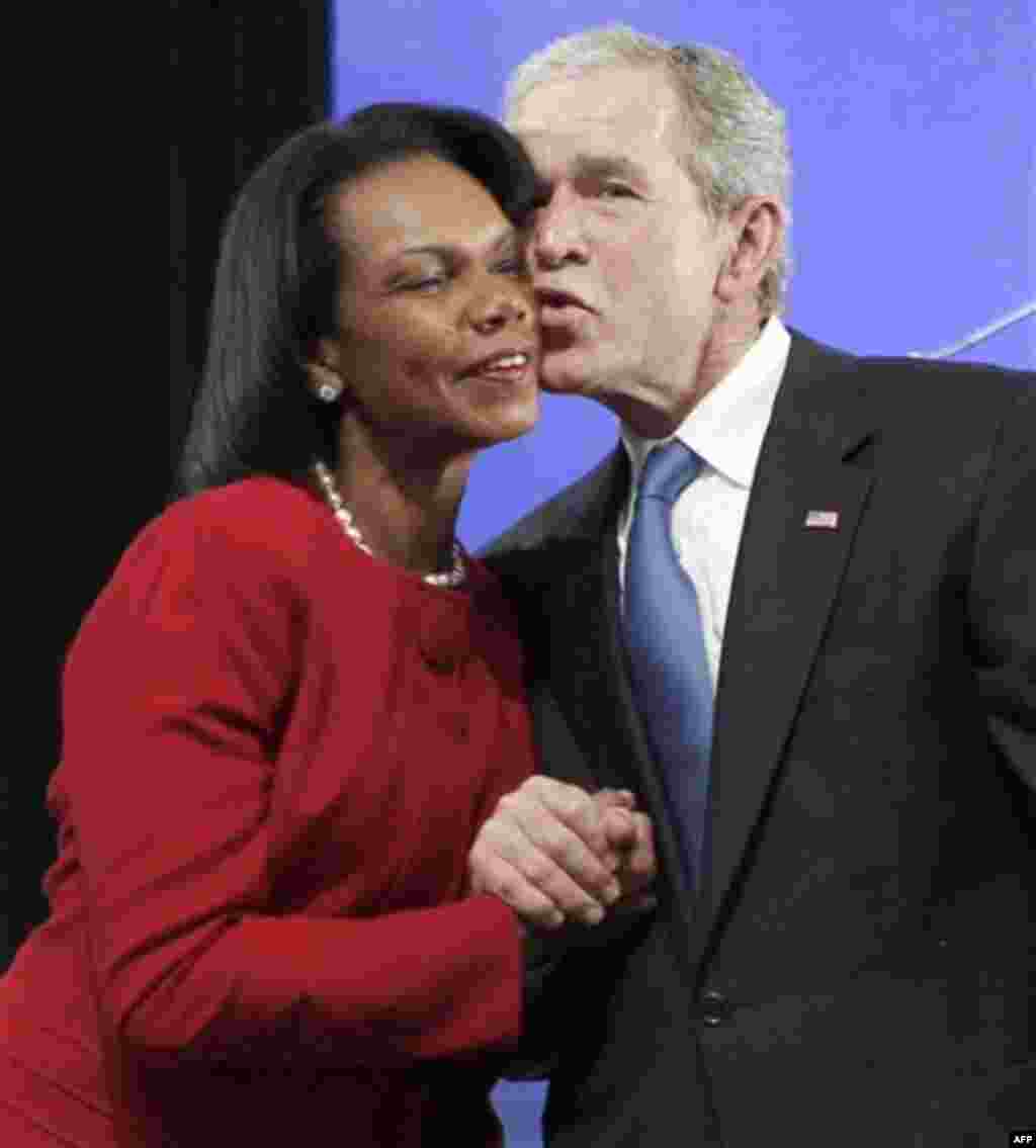 Former President George W. Bush, right, kisses former Secretary of State Condoleezza Rice during the ground breaking ceremony for the President George W. Bush Presidential Center in Dallas, Tuesday, Nov. 16, 2010. (AP Photo/LM Otero)