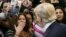 FILE - A woman blows a kiss to Republican presidential candidate Donald Trump (R) after Trump autographed her chest at his campaign rally in Manassas, Virginia, Dec. 2, 2015. 