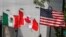 FILE - Flags of the U.S., Canada and Mexico fly next to each other in Detroit, Aug. 29, 2018. 