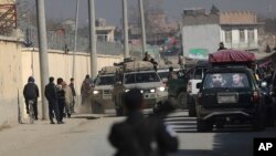Afghan security forces' vehicles are seen at the site of a shootout in Kabul, Afghanistan, Monday, Dec. 2, 2019.