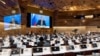 Russian Foreign Minister Sergey Lavrov's (on screen) pre-recorded video message is played in a nearly empty chamber of the U.N. Human Rights Council at the European headquarters of the United Nations in Geneva, Switzerland, March 1, 2022. 