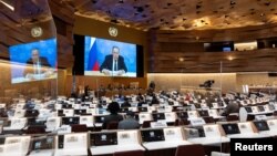 Russian Foreign Minister Sergey Lavrov's (on screen) pre-recorded video message is played in a nearly empty chamber of the U.N. Human Rights Council at the European headquarters of the United Nations in Geneva, Switzerland, March 1, 2022. 