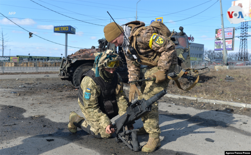 Combatientes de defensa territorial de Ucrania prueban un lanzagranadas automático que fue tomado de un vehículo de la infantería rusa.