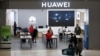 Customers and employees are seen at a Huawei store at Sandton City mall in Sandton, South Africa, Feb. 16, 2022.
