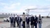 Taiwan's Foreign Minister Joseph Wu, fourth from right, stands with an American delegation including former Chairman of the Joint Chiefs Adm. Mike Mullen, third from right, as they arrive at Taipei Songshan Airport in Taipei, Taiwan, Tuesday, March 1, 2022.