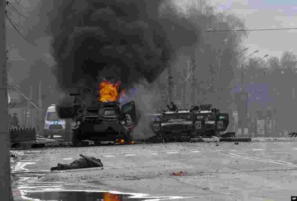 A Russian armored personnel carrier burns amid damaged and abandoned light utility vehicles after fighting in Kharkiv, Ukraine, Feb. 27, 2022.&nbsp;