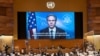 U.S. Secretary of State Antony Blinken appears on a screen as he delivers a speech during the 49th session of the U.N. Human Rights Council at the European headquarters of the United Nations in Geneva, Switzerland, March 1, 2022. 