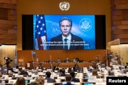 U.S. Secretary of State Antony Blinken appears on a screen as he delivers a speech during the 49th session of the U.N. Human Rights Council at the European headquarters of the United Nations in Geneva, Switzerland, March 1, 2022.