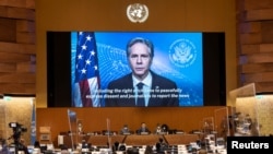 U.S. Secretary of State Antony Blinken appears on a screen as he delivers a speech during the 49th session of the U.N. Human Rights Council at the European headquarters of the United Nations in Geneva, Switzerland, March 1, 2022. 